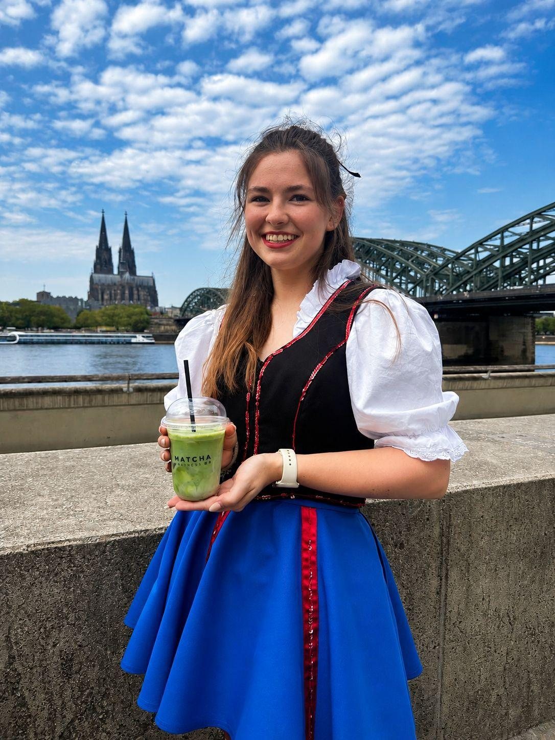 Funkemariechen mit Iced Matcha vor dem Kölner Dom